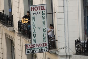 A man plays guitar on a tenement balcony during the second day of total quarantine in Buenos Aires on Saturday.