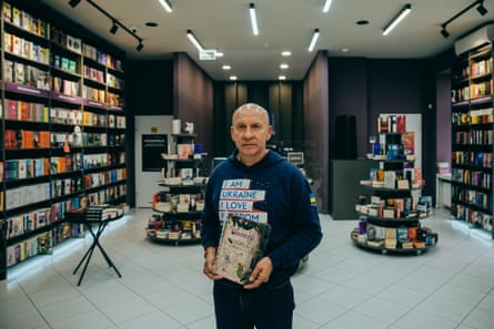 Viktor Kruglov, the co-founder and chief executive of the publisher Ranok, with the burnt pages, which survived in the Russian attack on the book warehouse.