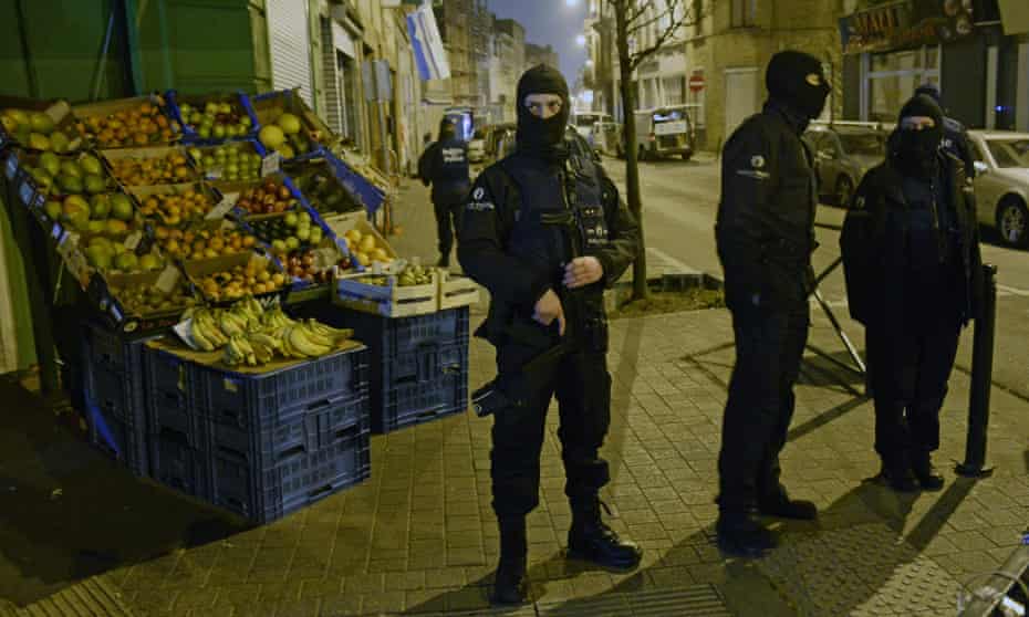 Policemen stand guard in Molenbeek after last week’s attacks.