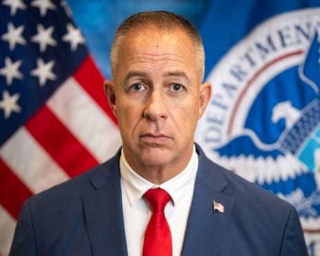 a man in a suit looks straight ahead