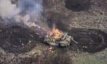 A screen showing a drone photo of a Russian tank