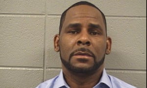 R Kelly poses for a mugshot photo after being arrested for $161,663 in unpaid child support earlier this week.