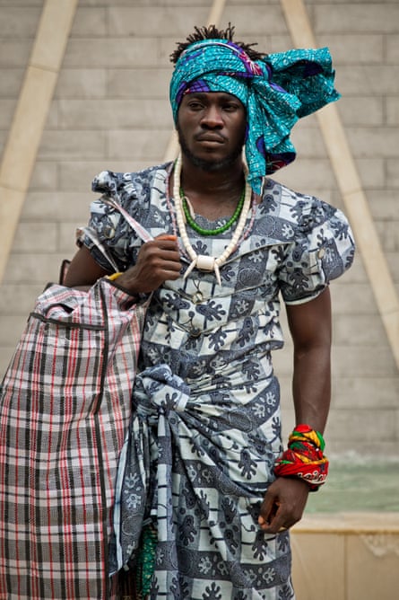 Serge Attukwei Clottey walks through Accra in his mother’s clothes.