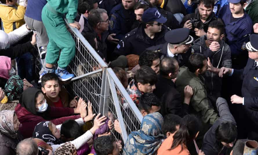 Migrants block the entrance of the Hellinikon camp in Athens during a protest over poor living conditions