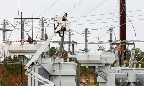 Duke Energy personnel work to restore power in Carthage, North Carolina, on 4 December.