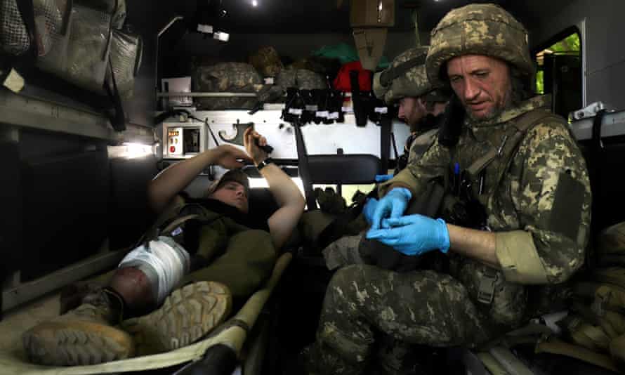 Ukrainian medic tends to an injured serviceman close to the front near Svitlodarsk.