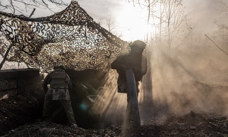 Ukrainian soldiers collect the remains of artillery shells at their fighting position