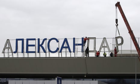 Workers removing the sign saying ‘Alexander the Great airport’ in Skopje in February.