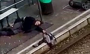Brussels suspect holds a rucksack over tram tracks