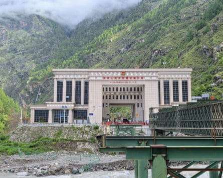 The Chinese immigration centre on the Tibet border. The green Friendship Bridge which crosses the river between Tibet and Nepal can be seen in the foreground.