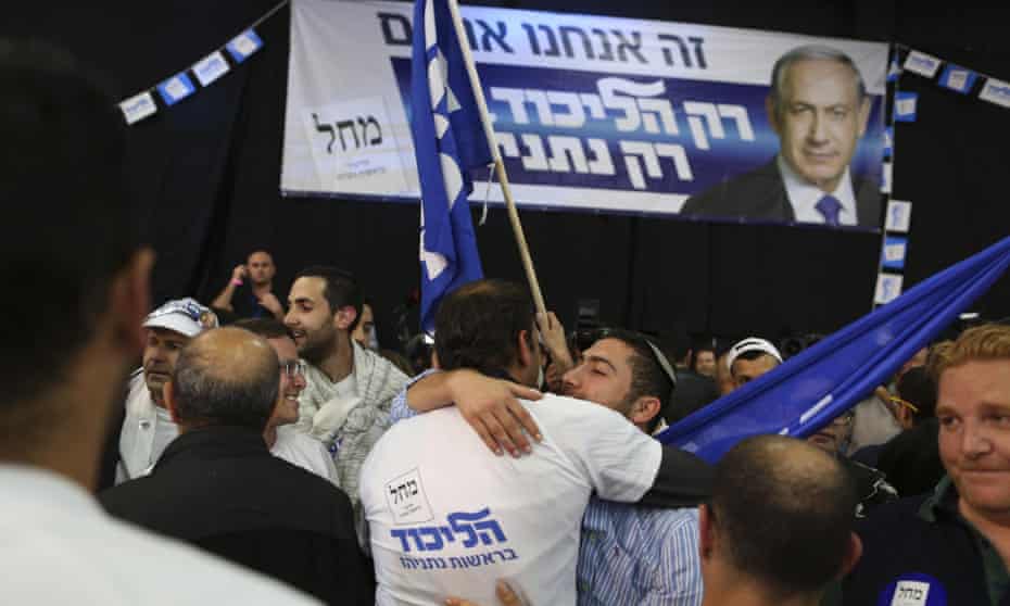 Israeli Likud Party supporters react to the exit polls while they wait for the announcement of the first official results of Israel’s parliamentary elections.