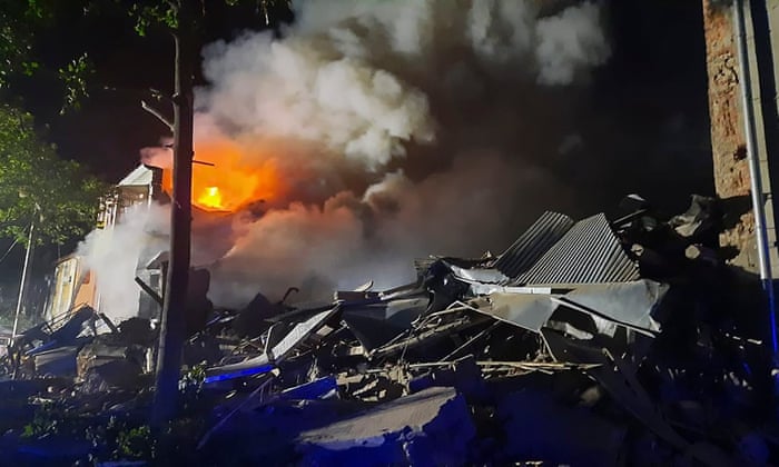 A handout photo made available by the Ukrainian state emergency service shows rescuers putting out a fire at a residential hall after a rocket hit the Saltivka residential area in Kharkiv on Wednesday.