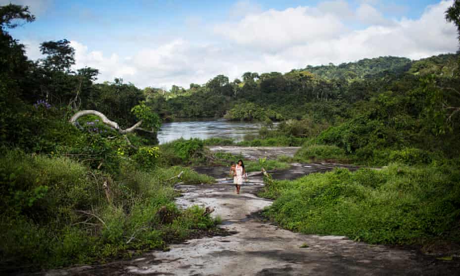 A Xikrin woman walks back to her village from the Cateté River in Brazil