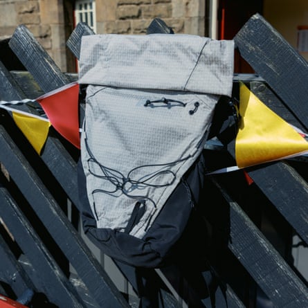 EMS Glacier Lightweight Roll Top 20l on a wooden bench on top of some bunting
