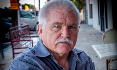 A gray-haired older man with a mustache.