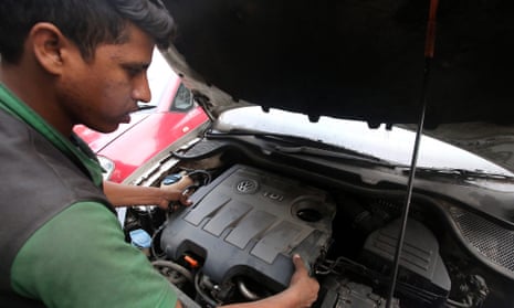 A mechanic repairs a VW car in India, where the company will recall 324,000 diesel vehicles.