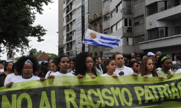 People march against racism in downtown Montevideo on 19 December 2012, after a 27-year-old African-Uruguayan woman was attacked outside of a nightclub.
