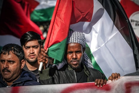 People hold Palestinian flags as they attend a demonstration under the slogan 'stop the genocide' in Naples, Italy, on Friday.