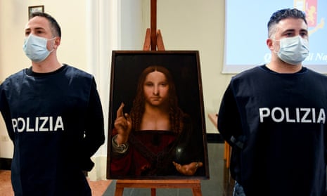 Police officers stand next to the recovered Salvator Mundi painting