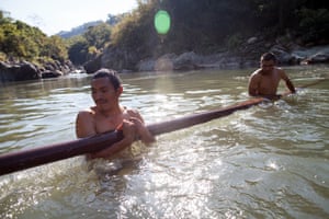 Lenca men retrieve part of a bridge in the Gualcarque river at Río Blanco, Intibucá