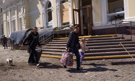 People try to find shelter after a Russian airstrike on a train station in Kherson, Ukraine, on Wednesday.