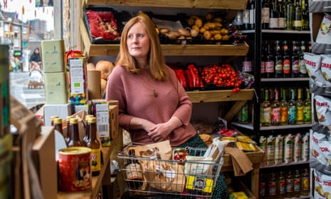 Lizzy Davies in The Community Larder store with a basket of food