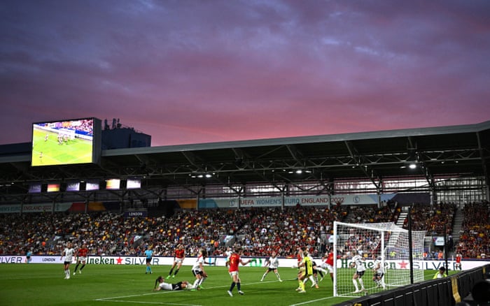 The German defense takes care of a Spanish corner under a pleasantly colored night sky at the Brentford Community Stadium.