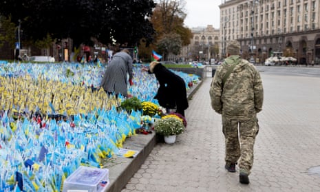A soldier is seen walking past the memorial for fallen soldiers at the Independent Square.