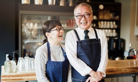 Senior couple cafe owners working in cafe together