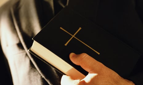 Priest holding a bible