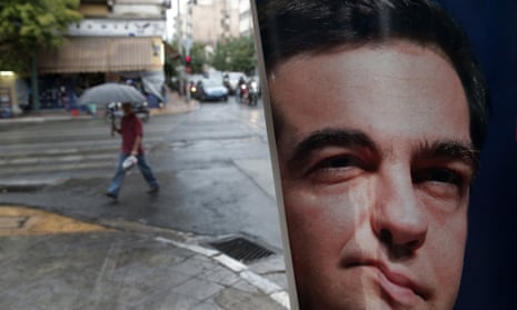 A man walks past a poster of left-wing Syriza party leader Alexis Tsipras in Athens.
