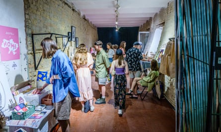 Visitors take in the works of craft producers selling their items in the ribbon factory.