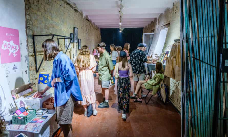 Visitors take in the works of craft producers selling their items in the ribbon factory.