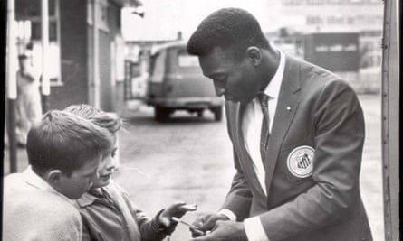 Pele signs an autograph after arriving for the game against Sheffield Wednesday, in 1962.