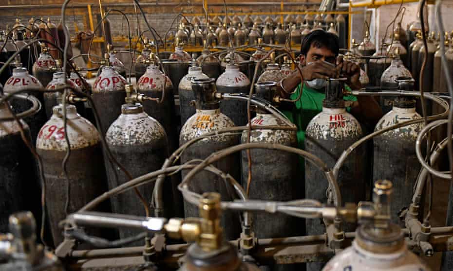 Workers sort oxygen cylinders for hospitals at a facility on the outskirts of Amritsar, India.