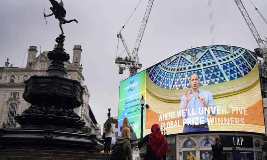 People watch as the Duke of Cambridge features in the trailer for the Earthshot prize in Piccadilly Circus, central London.