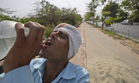 A laborer drinks water to quench his thirst on a hot day in New Delhi, India, Monday, May 2, 2022. The Indian capital, like many other parts of South Asia, is in the midst of a record-shattering heatwave. (AP Photo/Manish Swarup)