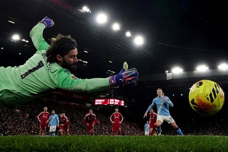 Manchester City’s Erling Haaland hits a penalty past Alisson.