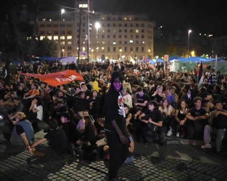Protestors sit as they take part in a demonstration against evictions and high rent prices on plaza Catalunya in Barcelona.