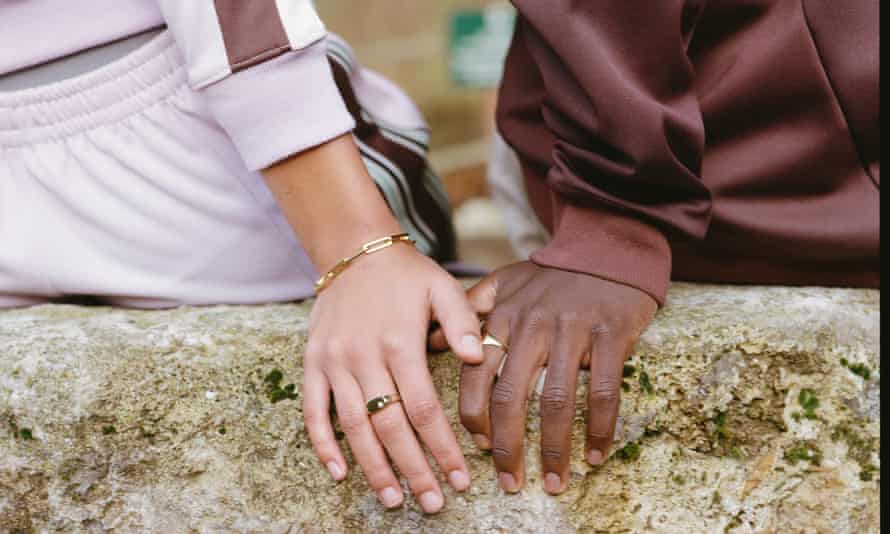 Teens' hands sitting on a wall