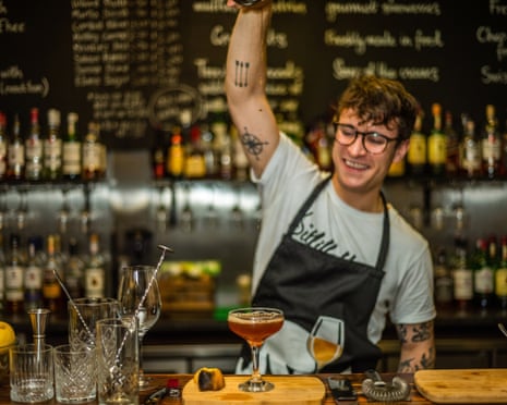 Professional young bartender working in nightclub.
