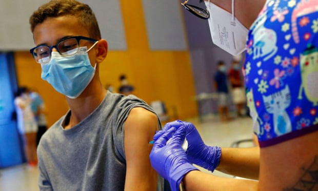A 14-year-old boy receives the Moderna vaccine in Spain