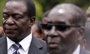 Emmerson Mnangagwa, left, stands behind the Zimbabwean president Robert Mugabe after his swearing-in ceremony at State House in Harare in December 2014.