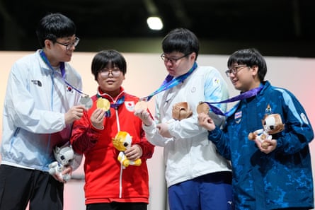 Medalists Kang Dong-shin of South Korea, silver, Yuki Kurihara of Japan, gold, and bronze medalists Kuo Tzu-ang of Taiwan and Tanarak Wongkitikun of Thailand celebrate after the Puyo Puyo Champions esports final at the Asian Games in Nagoya on Saturday.