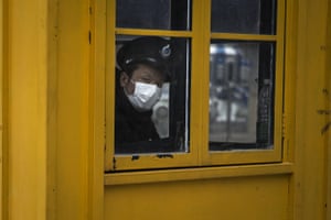 A security guard looks out of the window of a sentry box in Hubei province.