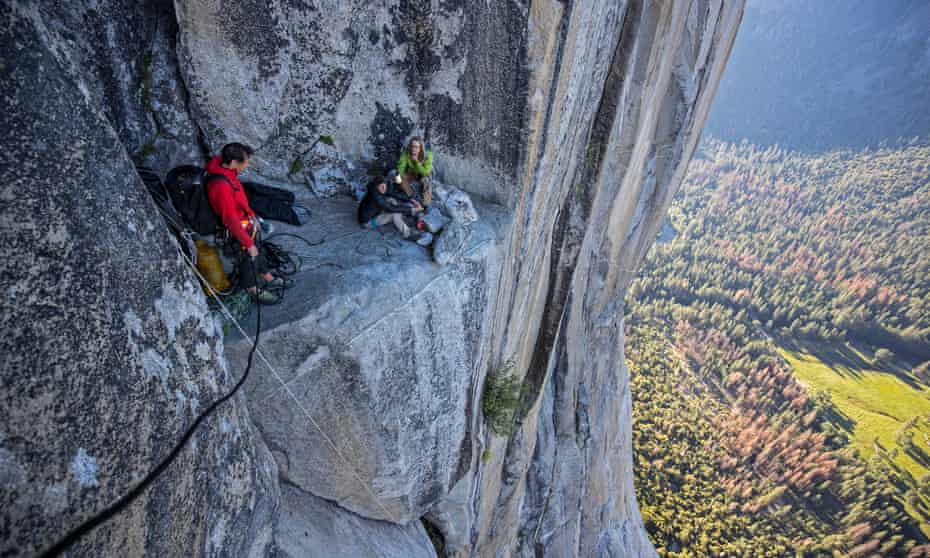 Alex Honnold meeting a couple climbers as he rappels El Capitan’s Freerider route to practice on the climb before his free solo attempt in Free Solo