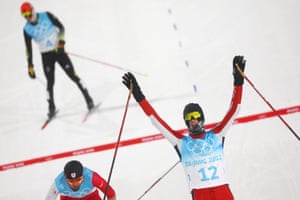 Joergen Graabak of Norway celebrates as he crosses the finish line of the Individual Gundersen to win gold in the Nordic Combined.