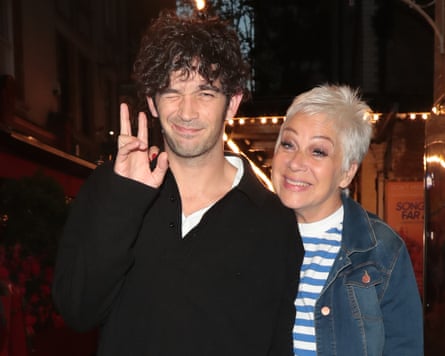 Denise Welch, on the right, standing with Matty Healy, both smiling at the camera