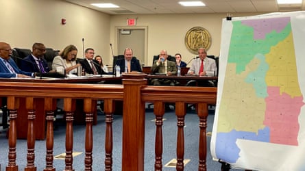 A large map in the foreground and people sitting around a table in the background