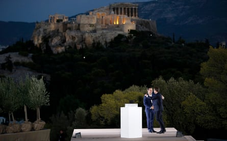 Greek prime minister Alexis Tsipras hugs French president Emmanuel Macron after delivering a speech atop the Pnyx hill.